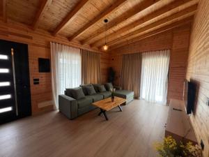a living room with a couch and a table at Villa Manuel in Bajkaj