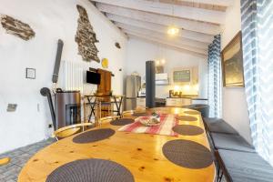 a large wooden table in a room with a kitchen at Ferienhaus Enztal in Zweifelscheid