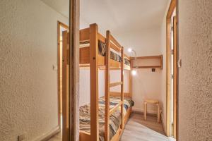 a bedroom with two bunk beds in a room at Studio Alpe d'huez in LʼHuez