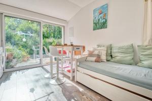 a room with a couch and a table and a window at Gite L'oiseau Du Paradis in Ribérac +15 photos