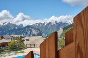 a view from the balcony of a resort with mountains at Studio Alpe d'huez in LʼHuez