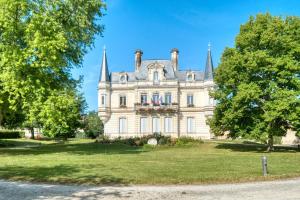 an old castle on a field with trees at Gite L'oiseau Du Paradis in Ribérac