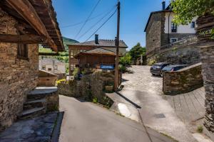 a street in a village with a building at Puente del Narcea 3 in Cibuyo