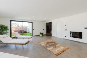 a living room with white furniture and a fireplace at Gc Luxury Apartments e Spa in Santa Margherita di Belice