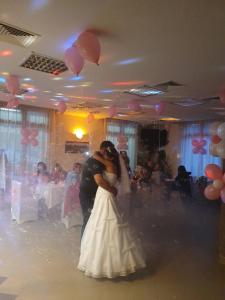 a bride and groom dancing on the dance floor at Yagodina Family Hotel in Yagodina