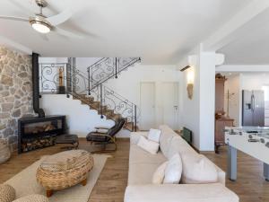 a living room with a couch and a fireplace at Villa Olivia by Interhome in Šestanovac