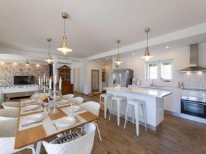 a kitchen and dining room with a table and chairs at Villa Olivia by Interhome in Šestanovac