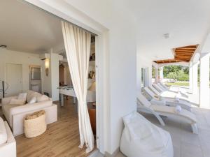 a living room with white furniture and a table at Villa Olivia by Interhome in Šestanovac +39 photos