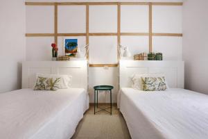 two beds sitting next to each other in a room at Abundia House in Caleta De Fuste