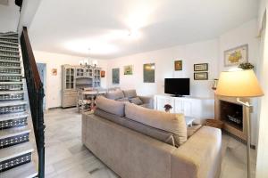 a living room with a couch and a fireplace at Chalet Cormoran in Chiclana de la Frontera