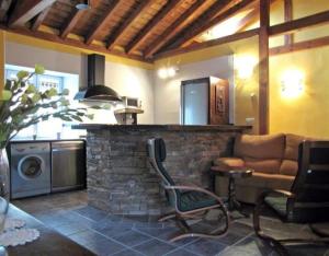 a living room with a couch and a stone fireplace at Las Frascuelas in Almajano