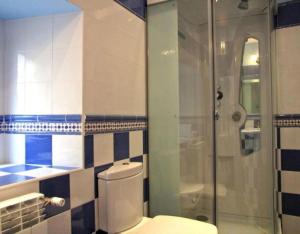 a bathroom with a toilet and a glass shower at Las Frascuelas in Almajano +9 photos