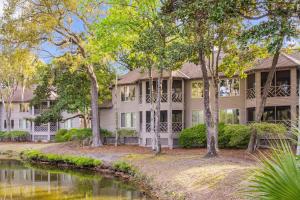 a large house with trees in front of a river at 4826 Green Dolphin Way in Kiawah Island