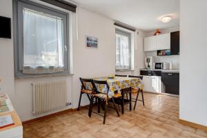 a kitchen with a table and chairs in a room at Ciclamino Standard Vittoria in San Lorenzo in Banale