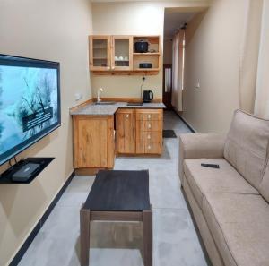 a living room with a couch and a flat screen tv at Al-mendhiry Apartment in Zanzibar City
