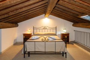 a bedroom with a bed in a room with wooden ceilings at Borgo San Carlo in Santa Luce +240 photos