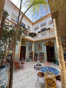 a large room with tables and chairs and a ceiling at RIAD ESMERALDA By Dar Ouezzani in Rabat