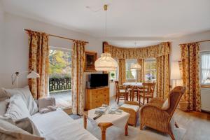 a living room with a couch and a table at Seeberg - Haus Annamirl in Bayrischzell