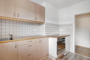 a kitchen with a sink and a stove at Wohnung Hochstaufen in Inzell +13 photos