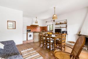 a kitchen and dining room with a table and chairs at El Madroño in El Palmar +17 photos