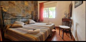 a bedroom with a large bed with two pillows on it at La Granja in Los Llanos de Aridane