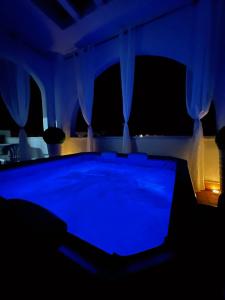a pool table in a room with blue lighting at Kalispera Residence in Scalea