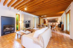 a living room with a white couch and a fireplace at Villa Cala Bona in Cala Bona