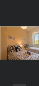 a bedroom with two beds and a table in it at Casa Vacanza Sa Petra Ruja B in Siniscola +2 photos