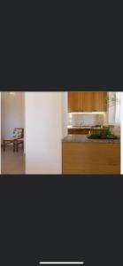 a kitchen with wooden cabinets and a counter top at Casa Vacanza Sa Petra Ruja B in Siniscola