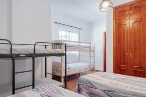 a bedroom with two bunk beds and a closet at Sunset El Tejar in Almogía +21 photos