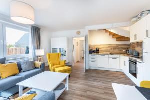 a living room with a couch and a table at Haus Hein Mück in Norden +24 photos