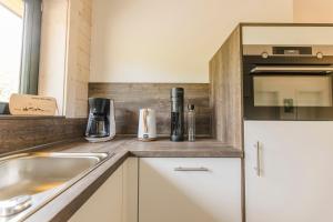 a kitchen with a sink and a counter top at Blockhaus 2 in Eslohe +34 photos