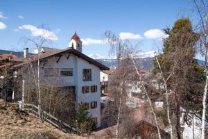 a white building with a tower on top of a hill at Apartment 4 - Zur Sonne in Laion