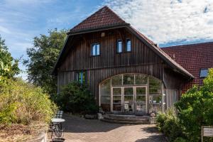 a large wooden barn with a large window at Hof Wegwarte in Weilheim
