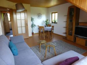 a living room with a couch and a table at Moorwiesenhof in Ostrach