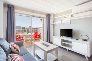 a living room with a couch and a tv at Gandiazar Beach in Playa de Gandia