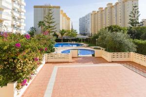 a resort with a swimming pool and some buildings at Gandiazar Beach in Playa de Gandia