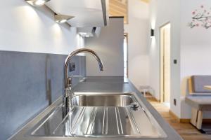 a stainless steel sink in a kitchen at Living Lerchna - Schöne Aussicht 2 in Maranza +22 photos