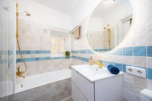 a bathroom with a tub and a sink and a shower at Marina 48 Seafront Apartment in Port de Soller +24 photos