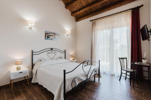 a bedroom with a bed and a large window at Siciliantica - Rilievo in Rilievo