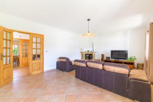 a living room with a couch and a television at Casa Nelson e Esperanca in Vila Nova de Milfontes