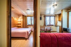 a bedroom with a bed and a dining room at Studio Chénives - Morzine in Morzine