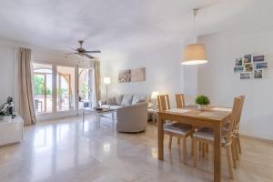 a dining room and living room with a table and chairs at Simplicity luxury apartment in Altea