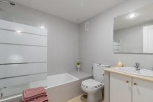 a white bathroom with a toilet and a sink at Simplicity luxury apartment in Altea +16 photos