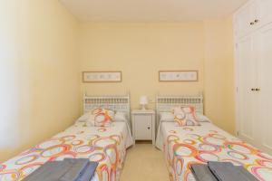 two beds in a small room with two at Simplicity luxury apartment in Altea