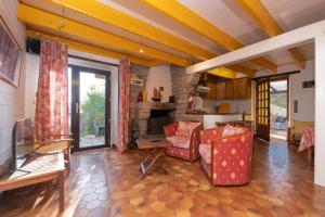 a living room with two chairs and a table at Maison proche de la mer in Arzon