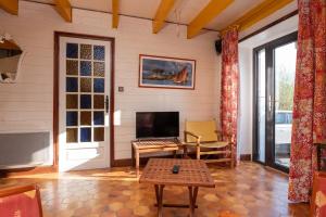 a living room with a fireplace and a tv at Maison proche de la mer in Arzon