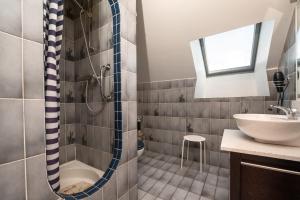 a bathroom with a shower and a sink at Maison proche de la mer in Arzon +12 photos