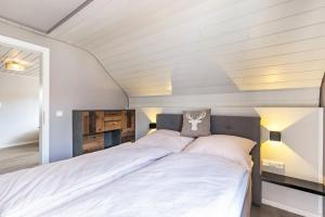 a bedroom with a large bed with white sheets at Premium Basislager in Albstadt