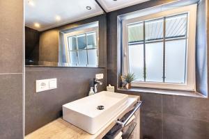 a bathroom with a white sink and a window at Premium Basislager in Albstadt +32 photos